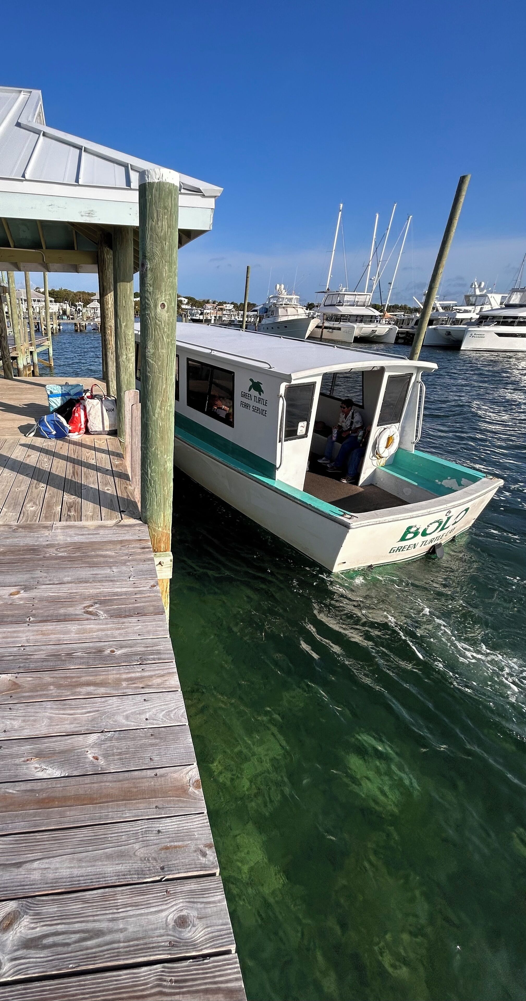 A boat docked at a pier with a wooden walkway.