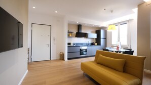 Een modern appartement met een woonkamer, keuken en eetgedeelte.