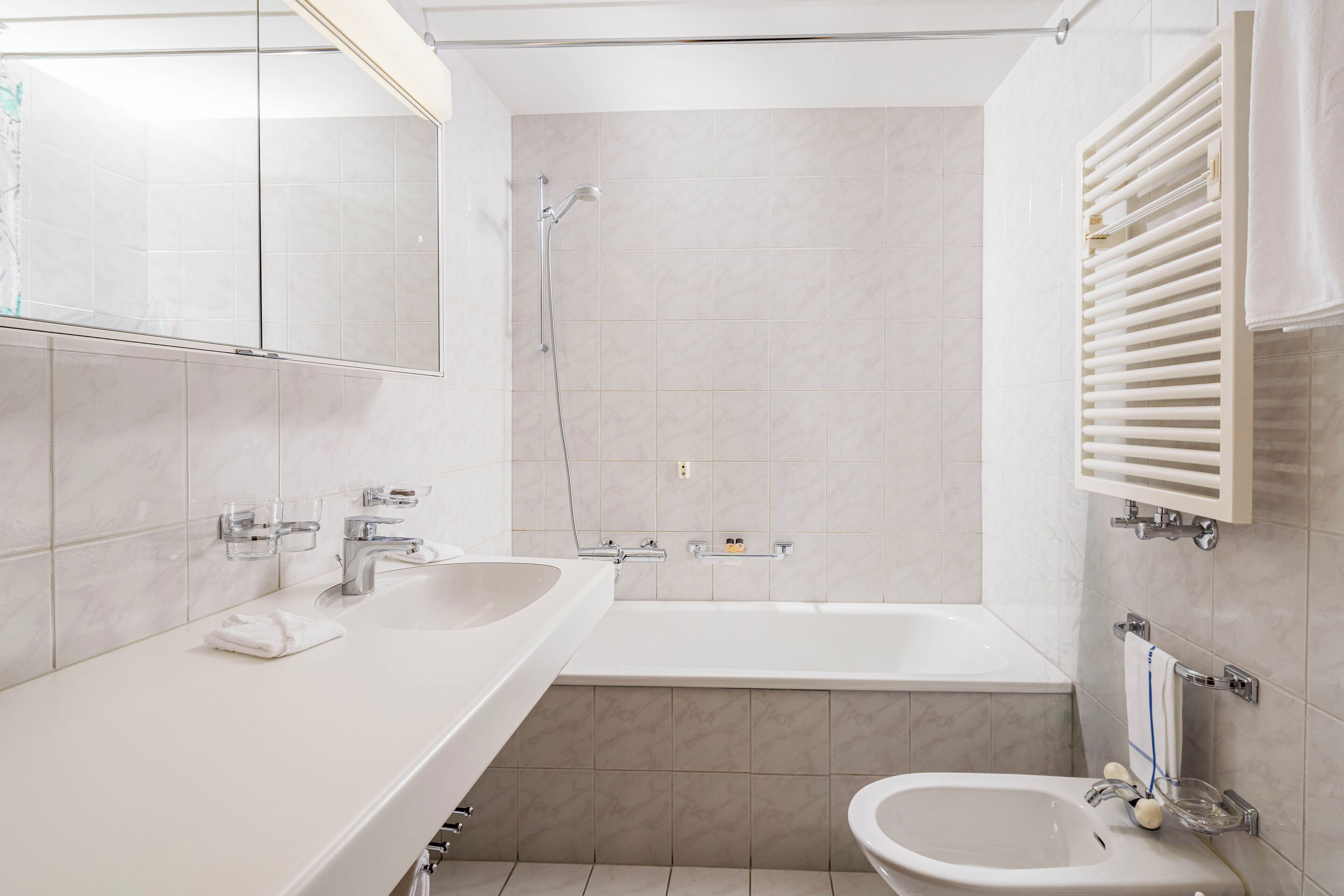 A modern bathroom with a bathtub, a sink, and a toilet.