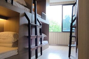 A bunk bed room with a window, a ladder, and a built-in shelf. - Rlan Boutique Hotel (Shanghai)