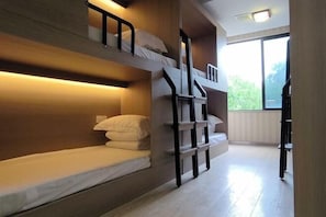 A bunk bed room with a wooden headboard, a staircase, and a large window. - Rlan Boutique Hotel (Shanghai)