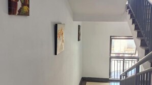 A staircase with a metal railing leading to a landing. - Rlan Boutique Hotel (Shanghai)