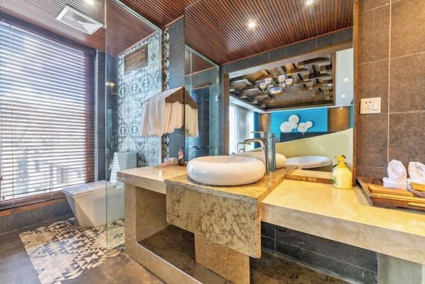 A modern bathroom with a large mirror, a round sink, and a shower area. - Gone with Wind coffee Holiday Courtyard (Lijiang)