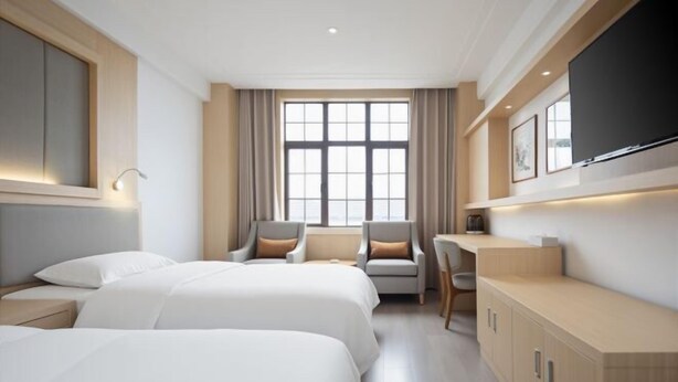 A hotel room with two beds, a desk, a chair, and a large window. - Kunlun Hotel (Nantong)