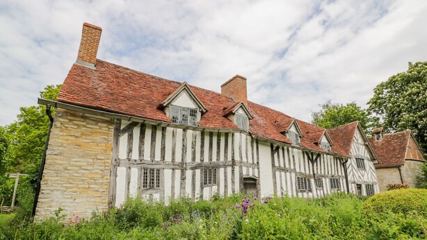 A traditional half-timbered house with a stone foundation and red-tiled roof. - Little Barn (Stratford-upon-Avon)