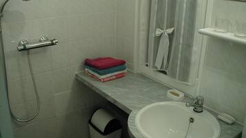 Een douche, handdoeken, toiletpapier