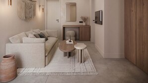 A modern living room with a sofa, coffee table, and a small rug.