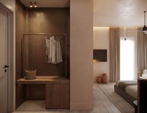 Ein modernes Schlafzimmer mit einer hölzernen Sitzbank, einem hängenden Kleiderständer, einem Nachttisch und einem großen Bett.