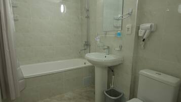 Habitación triple superior | Baño | Artículos de higiene personal gratuitos, secador de pelo y albornoces