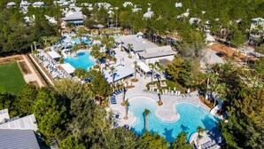 An aerial view of a resort with multiple swimming pools, a large building, and surrounding greenery. - Escape To WaterColor with Exclusive Beach Club Access and Free Bikes Included in Every Stay (Santa Rosa Beach)