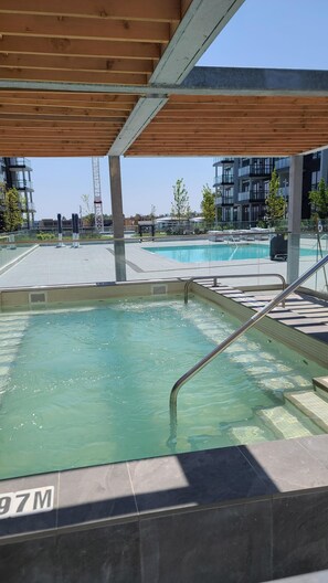 Outdoor pool - Cozy Lake Simcoe 2 bedroom condo with a garden walkout to the boardwalk/ Pier. (Innisfil)