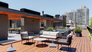 A rooftop terrace with outdoor seating, including a sofa and chairs, and a dining area with tables and chairs. - Luxury 1-bedroom apartment near WTC Montevideo with infinit pool (Montevideo)