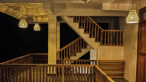 A wooden staircase with a railing, leading to an upper level. - The Woods - Tirthan Valley (Banjar)