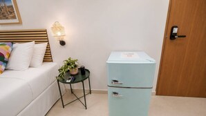 A bedroom with a bed, bedside table, lamp, and a two-door cabinet. -  Room 10: Cozy Urban Hideaway in Arts District (San Juan)