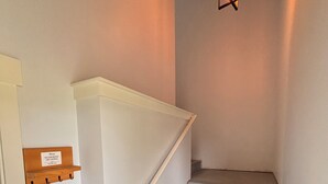 A staircase with a handrail, a wall-mounted light fixture, and a no-smoking sign. - Charming 2-bedroom attached apartment with AC, WiFi in adorable Creswell (Creswell)