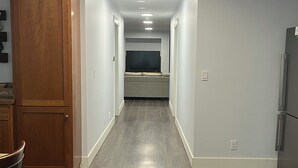 A narrow hallway with wooden flooring, white walls, and recessed lighting. - Charming 2-bedroom attached apartment with AC, WiFi in adorable Creswell (Creswell)