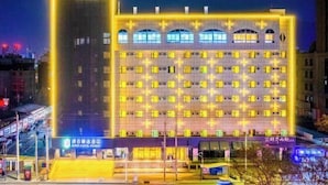 A multi-story hotel with a symmetrical facade, multiple windows, and a central entrance. - Super 8 Collection Hotel (Lanzhou Railway Station Hongxingxiang Subway Station) (Lanzhou)