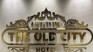 A hotel sign with "The Old City Hotel" written in large, ornate letters. - The Old City (Kanchipuram)