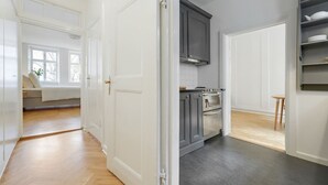 A modern kitchen with grey cabinets, a stove, and a built-in oven. - Beautiful apartment in the center of KBH (København)