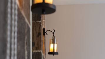 A stone wall with two wall-mounted lanterns.