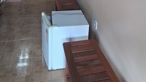 A hallway with a sink, a refrigerator, and a television mounted on the wall. - Pousada Sossego Ronaldo e Clarinha  (Santarem)