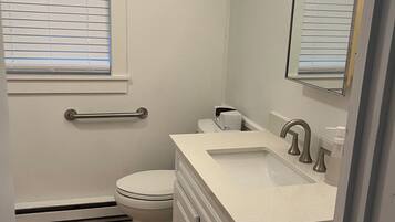 Shower, hair dryer, towels, toilet paper