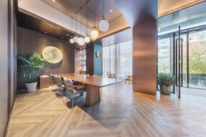 A modern conference room with a large table, chairs, and a potted plant. - Orange Hotel (Beijing West Railway Station South Square) (Beijing)