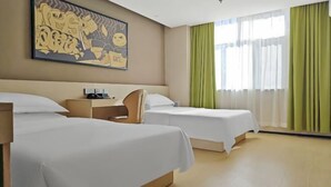 A hotel room with two beds, a desk, a chair, and a large wall painting. - IU Hotel Yining Shanghai City (Yining City)