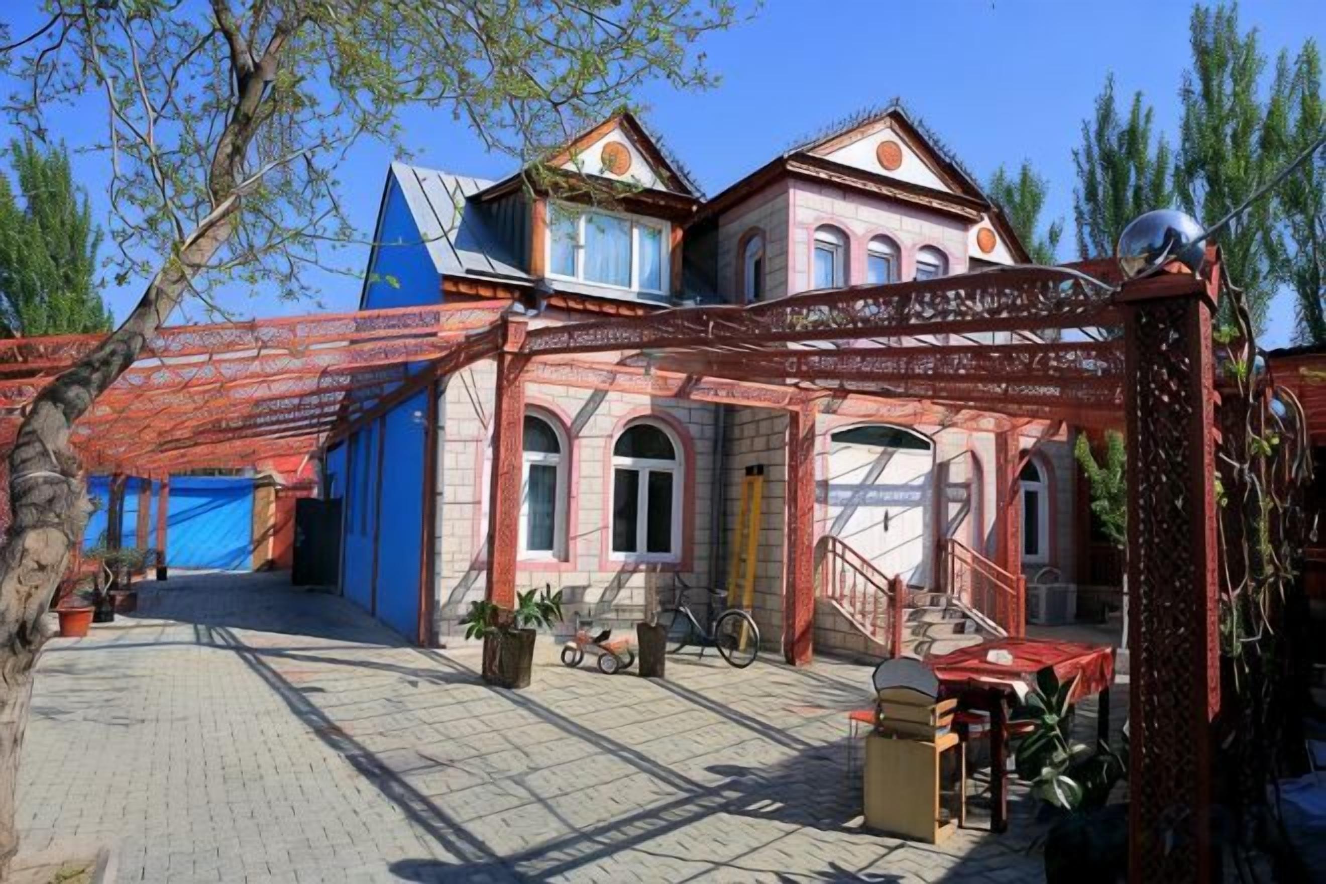 A traditional building with a covered courtyard, a staircase, and a bicycle.