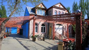 A traditional building with a covered courtyard, a staircase, and a bicycle.