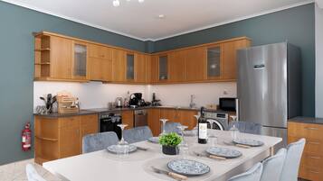 Deluxe Apartment, City View | Private kitchen | Dishwasher, electric kettle, highchair