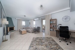 Deluxe Apartment, City View | Living area | 32-inch flat-screen TV with cable channels