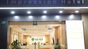 The entrance of the Impression Hotel with a reception area visible inside. - Shanghai Xinnuo Hotel (Shanghai)