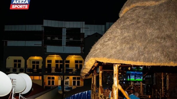 A thatched-roof structure with a wooden railing, likely a bar or lounge area, on a balcony with satellite dishes. - Mirton Hotel (Bujumbura)
