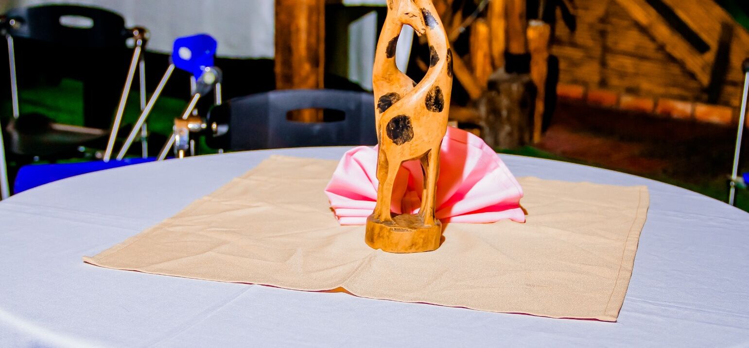 A table with a folded cloth and a wooden object on it.