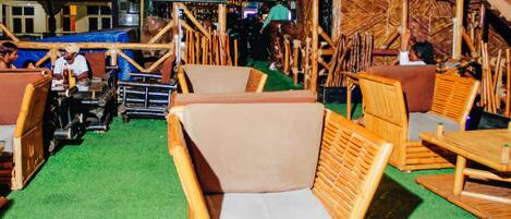 A rustic-themed bar area with wooden furniture and a green carpet.