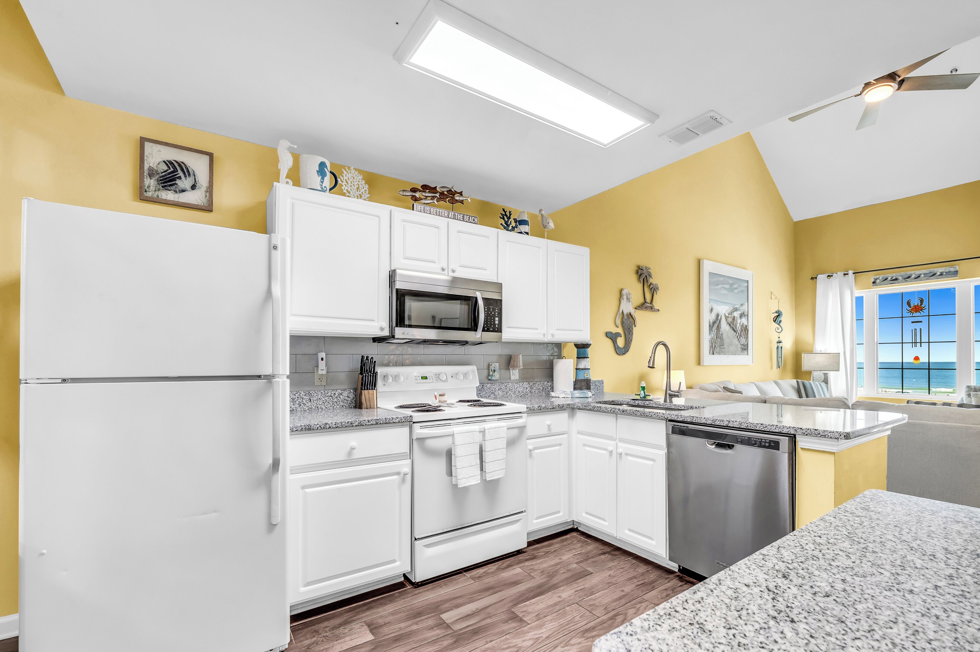 A kitchen with white cabinets, a stainless steel oven, and a dishwasher.
