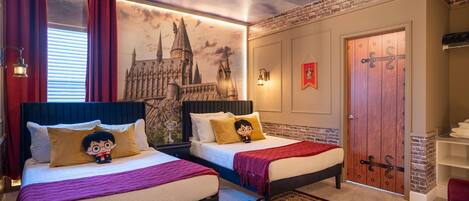 A bedroom with two beds, a mural of a castle, a red door, and a chandelier.