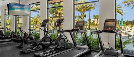 A gym with treadmills, stationary bikes, and elliptical machines.