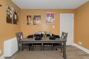 Enjoy meals with family and friends at this dining area, featuring a table for four and comfortable seating.