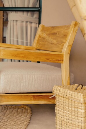 Relax in a cozy space with a natural wood chair and woven accents.