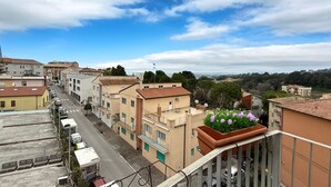 A residential street with buildings, a clear sky, and a distant view. - N297 - Numana, three-room apartment in the heart of the town (Numana)