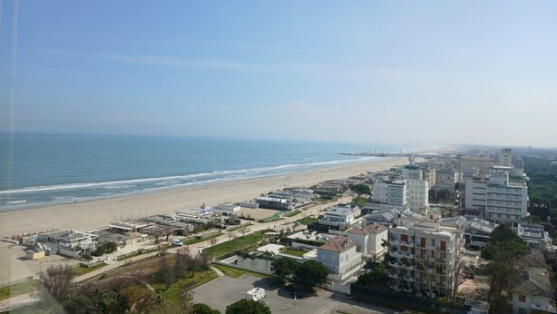 A coastal cityscape with a beach, buildings, and a clear sky. - CV011 - Milano Marittima, sea front three-room apartment with exclusive view (Cervia)