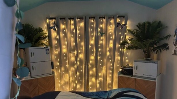 A bedroom with a bed, curtains with string lights, a small cabinet, and a potted plant. - Vacation Rental, Spa & Salt Room
Table Rock State Park
Fire-Pit ,Pet Friendly (Pickens)