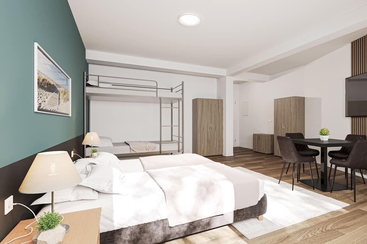 Una habitación de hotel moderna con una litera, un escritorio y un comedor.