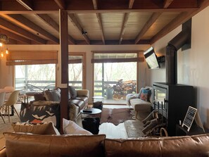 Smart TV, fireplace, books, computer monitors