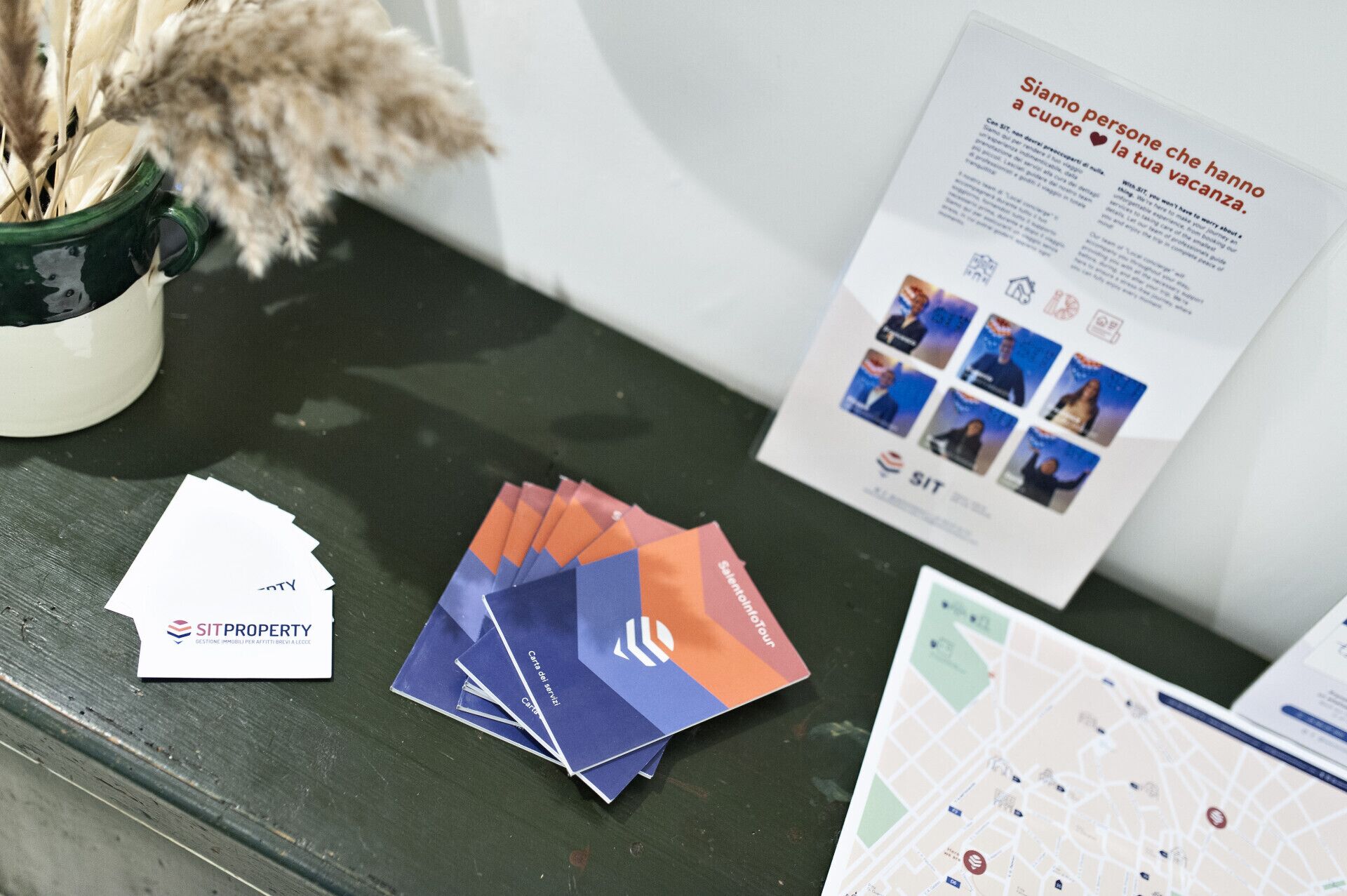 A table with promotional materials, including brochures and a map, likely for a property or service.