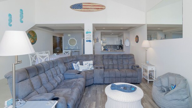 A modern living room with a sectional sofa, a bean bag, and a round coffee table. - 357 Ocean View (Pismo Beach)