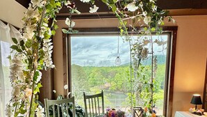 A wedding reception setup with a floral arch, tables with white tablecloths, and chairs. - Cozy cabin and TUBING!  Swim, Horses, hiking, lake-3 mi from Helen! Relax!  (Cleveland)