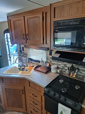Fridge, microwave, stovetop, coffee/tea maker
